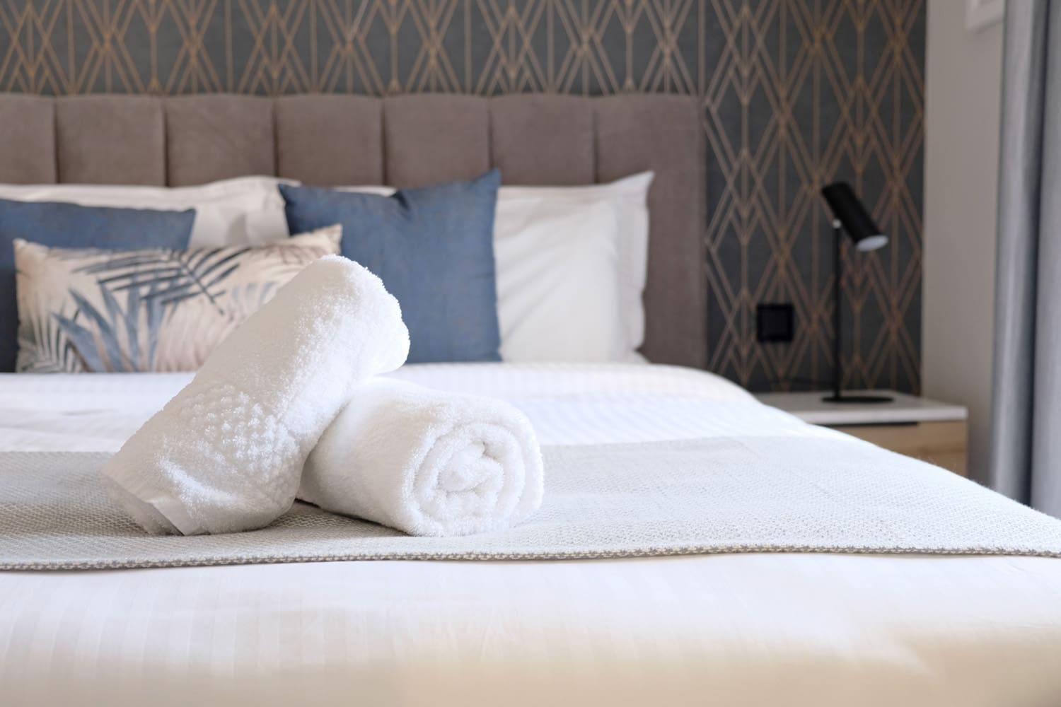 Hotel bed with Fresh Sheets and Laundered Towels